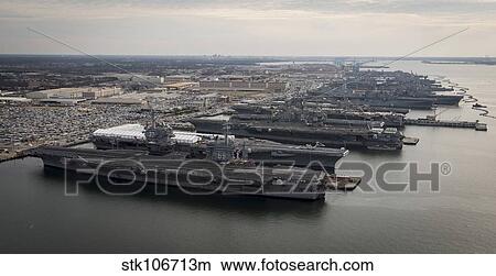 Aircraft carriers in port at Naval Station Norfolk, Virginia. View Large Photo Image Picture - Aircraft carriers in port at Naval Station Norfolk, Virginia.. Fotosearch