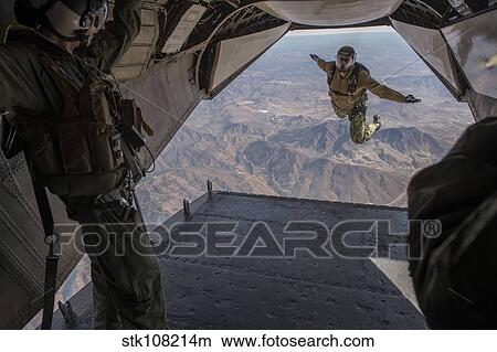 Aircrewman jumps from a C2-A Greyhound. View Large Photo Image Picture - Aircrewman jumps from a C2-A Greyhound.. Fotosearch