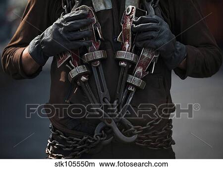 Airman carries aircraft tie-down chains on the flight deck of USS Carl Vinson. View Large Photo Image Picture - Airman carries aircraft tie-down chains on the flight deck of USS Carl Vinson.. Fotosearch