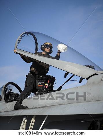 Airman cleans the canopy of an F/A-18C Hornet. View Large Photo Image Picture - Airman cleans the canopy of an F/A-18C Hornet.. Fotosearch