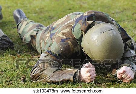 Picture - Airman crawls through a wet field during individual core competency skills training.. Fotosearch