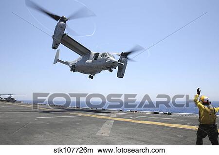 Airman directs the take-off an MV-22 Osprey. View Large Photo Image Picture - Airman directs the take-off an MV-22 Osprey.. Fotosearch