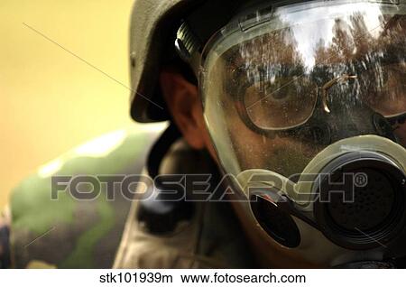 Airman dons a gas mask during a simulated gas attack. View Large Photo Image Picture - Airman dons a gas mask during a simulated gas attack.. Fotosearch
