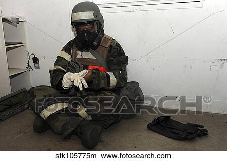 Airman dons his chemical warfare defense ensemble. View Large Photo Image Picture - Airman dons his chemical warfare defense ensemble.. Fotosearch
