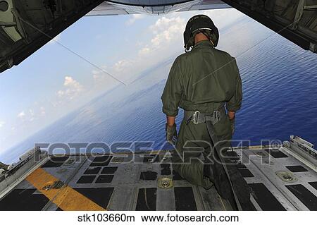 Airman observes the waters of the Gulf of Mexico from a C-130 Hercules. View Large Photo Image Picture - Airman observes the waters of the Gulf of Mexico from a C-130 Hercules.. Fotosearch