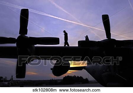 Airman performs a pre-flight inspection on a C-130 Hercules. View Large Photo Image Picture - Airman performs a pre-flight inspection on a C-130 Hercules.. Fotosearch