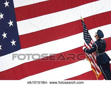 Airman posts the American flag during a change of command ceremony. View Large Photo Image Picture - Airman posts the American flag during a change of command ceremony.. Fotosearch