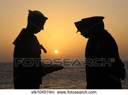 Airman presents commanding officer with an American flag during a burial at sea. View Large Photo Image Picture - Airman presents commanding officer with an American flag during a burial at sea.. Fotosearch