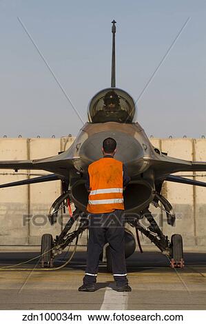 Airman signals to the pilot of an F-16A Netz of the Israeli Air Force. View Large Photo Image Picture - Airman signals to the pilot of an F-16A Netz of the Israeli Air Force.. Fotosearch
