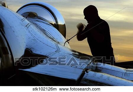 Airman tightens down the canopy of an F-16 Fighting Falcon. View Large Photo Image Picture - Airman tightens down the canopy of an F-16 Fighting Falcon.. Fotosearch