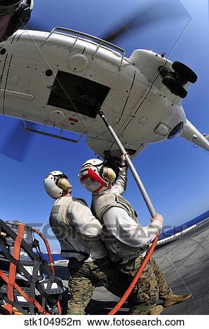 Airmen attach pallet rigs to an SA-330J Puma helicopter aboard USS Essex. View Large Photo Image Picture - Airmen attach pallet rigs to an SA-330J Puma helicopter aboard USS Essex.. Fotosearch