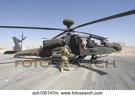 Airmen board an Apache helicopter at Camp Bastion, Afghanistan. View Large Photo Image Picture - Airmen board an Apache helicopter at Camp Bastion, Afghanistan.. Fotosearch