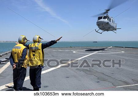 Airmen direct a Spanish navy AB-212 helicopter onto the flight deck of USS Gunston Hall. View Large Photo Image Picture - Airmen direct a Spanish navy AB-212 helicopter onto the flight deck of USS Gunston Hall.. Fotosearch