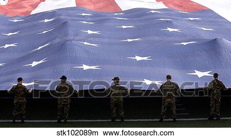 Airmen present the American Flag during the National Anthem. View Large Photo Image Picture - Airmen present the American Flag during the National Anthem.. Fotosearch