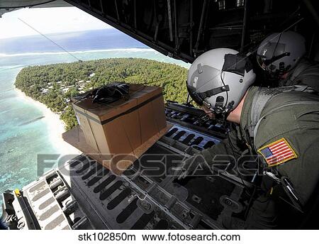 Airmen push out a pallet of donated goods over the Island of Yap from a C-130 Hercules. View Large Photo Image Picture - Airmen push out a pallet of donated goods over the Island of Yap from a C-130 Hercules.. Fotosearch