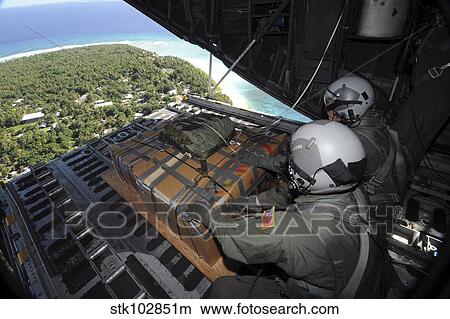 Airmen push out a pallet of donated goods over the Island of Yap from a C-130 Hercules. View Large Photo Image Picture - Airmen push out a pallet of donated goods over the Island of Yap from a C-130 Hercules.. Fotosearch