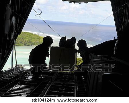 Airmen push out a pallet of donated goods from a C-130 Hercules. View Large Photo Image Picture - Airmen push out a pallet of donated goods from a C-130 Hercules.. Fotosearch