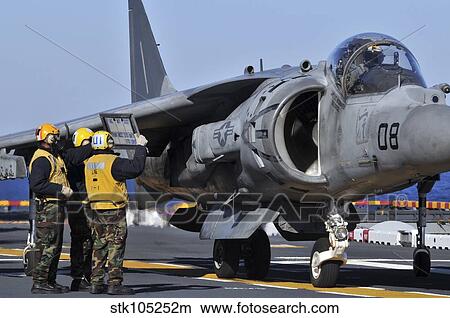 Airmen show flight information to an AV-8B Harrier pilot. View Large Photo Image Picture - Airmen show flight information to an AV-8B Harrier pilot.. Fotosearch