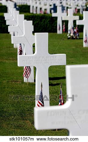 American flags rest in front of headstones at Madingley American Cemetery. View Large Photo Image Picture - American flags rest in front of headstones at Madingley American Cemetery.. Fotosearch