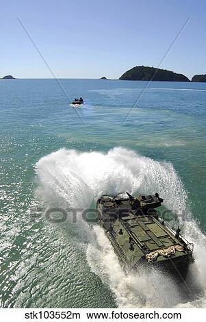 Amphibious Assault vehicles exit the well deck of amphibious transport dock ship USS Denver. View Large Photo Image Picture - Amphibious Assault vehicles exit the well deck of amphibious transport dock ship USS Denver.. Fotosearch