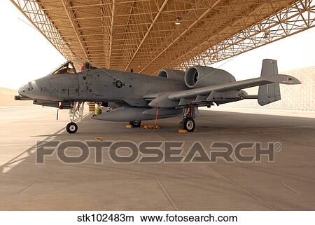An A-10 Thunderbolt II awaits a mission at an airbase. View Large Photo Image Picture - An A-10 Thunderbolt II awaits a mission at an airbase.. Fotosearch