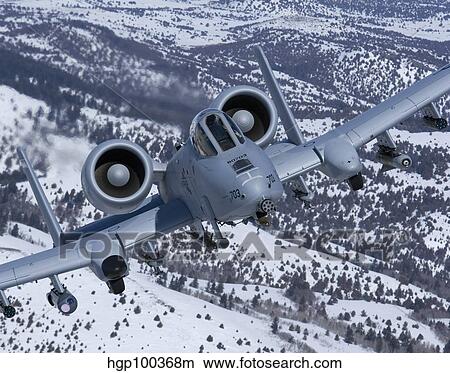 An A-10C Thunderbolt flies over the snowy Idaho countryside. View Large Photo Image Picture - An A-10C Thunderbolt flies over the snowy Idaho countryside.. Fotosearch