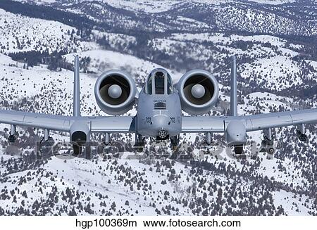 An A-10C Thunderbolt flies over the snowy Idaho countryside. View Large Photo Image Picture - An A-10C Thunderbolt flies over the snowy Idaho countryside.. Fotosearch