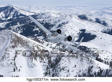 An A-10C Thunderbolt flies over the snowy Idaho countryside. View Large Photo Image Picture - An A-10C Thunderbolt flies over the snowy Idaho countryside.. Fotosearch