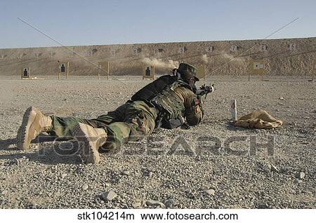 Picture - An Afghan Commando engages training targets on the firing range.. Fotosearch