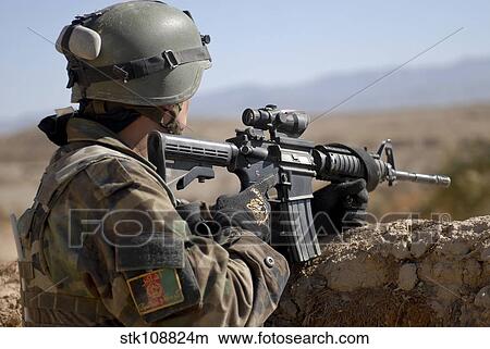 An Afghan Commando scans the horizon for enemy activity. View Large Photo Image Picture - An Afghan Commando scans the horizon for enemy activity.. Fotosearch