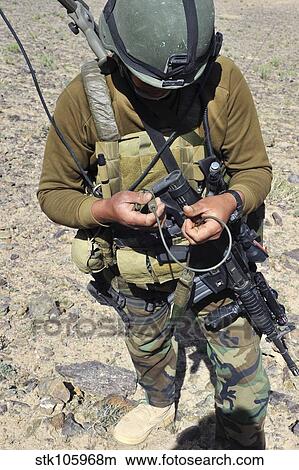 An Afghan National Army soldier prepares a detonation charge. View Large Photo Image Picture - An Afghan National Army soldier prepares a detonation charge.. Fotosearch