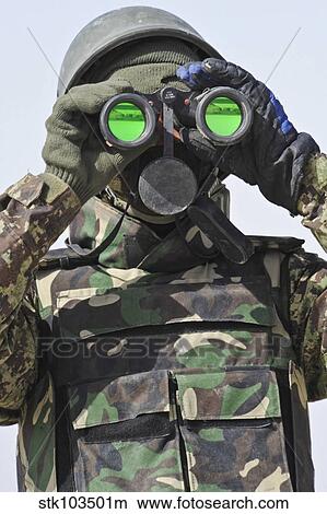 Picture - An Afghan National Army soldier scans the horizon for enemy movement.. Fotosearch