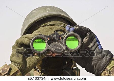 Picture - An Afghan soldier scans the horizon for enemy movements.. Fotosearch