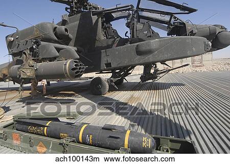 An AGM-114 Hellfire missile is ready to be loaded onto an AH-64 Apache. View Large Photo Image Picture - An AGM-114 Hellfire missile is ready to be loaded onto an AH-64 Apache.. Fotosearch