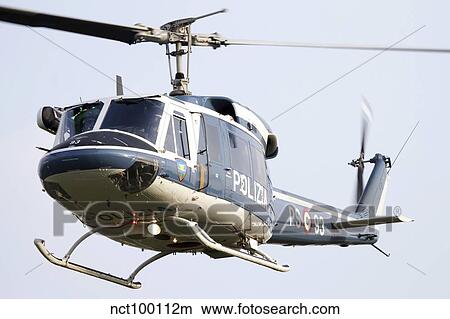 An Agusta Bell 212 of Italy's State Police in flight over Italy. View Large Photo Image Picture - An Agusta Bell 212 of Italy's State Police in flight over Italy.. Fotosearch