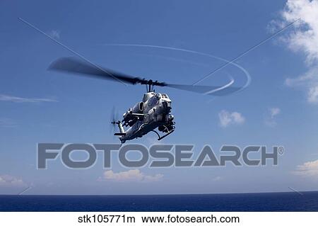 An AH-1 Cobra in flight over the Philippine Sea. View Large Photo Image Picture - An AH-1 Cobra in flight over the Philippine Sea.. Fotosearch