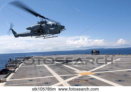 An AH-1W Super Cobra helicopter lands aboard USS Denver. View Large Photo Image Picture - An AH-1W Super Cobra helicopter lands aboard USS Denver.. Fotosearch