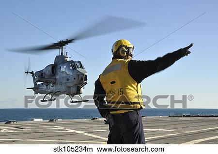 An AH-1W Super Cobra helicopter lifts off from USS Ponce. View Large Photo Image Picture - An AH-1W Super Cobra helicopter lifts off from USS Ponce.. Fotosearch