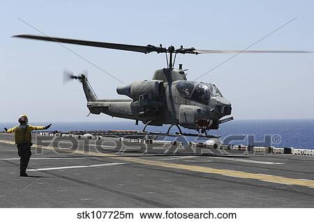 An AH-1W Super Cobra takes off from the flight deck of USS Kearsarge. View Large Photo Image Picture - An AH-1W Super Cobra takes off from the flight deck of USS Kearsarge.. Fotosearch