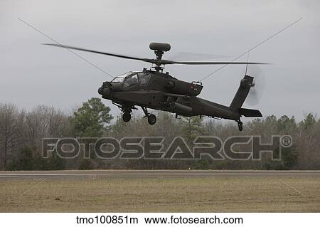 An AH-64 Apache helicopter in midair, Conroe, Texas. View Large Photo Image Picture - An AH-64 Apache helicopter in midair, Conroe, Texas.. Fotosearch