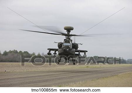An AH-64 Apache helicopter in midair, Conroe, Texas. View Large Photo Image Picture - An AH-64 Apache helicopter in midair, Conroe, Texas.. Fotosearch