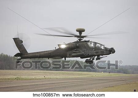An AH-64 Apache helicopter in midair, Conroe, Texas. View Large Photo Image Picture - An AH-64 Apache helicopter in midair, Conroe, Texas.. Fotosearch