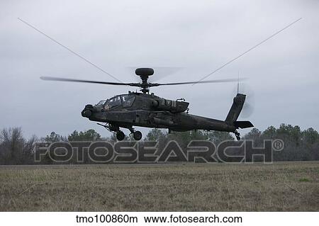 An AH-64 Apache helicopter in midair, Conroe, Texas. View Large Photo Image Picture - An AH-64 Apache helicopter in midair, Conroe, Texas.. Fotosearch