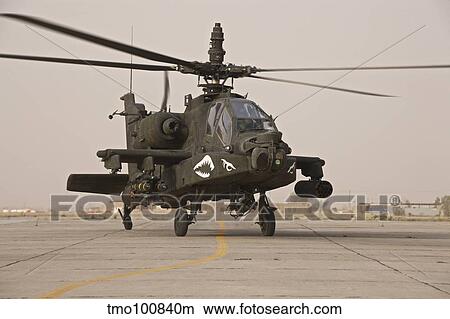 Picture - An AH-64 Apache helicopter taxiing on the flight line.. Fotosearch