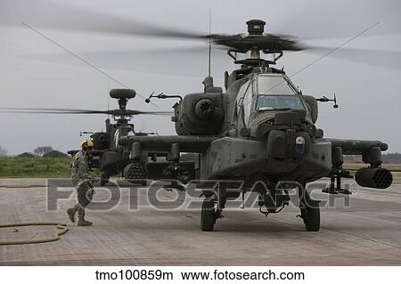 An AH-64 Apache helicopter undergoes refueling. View Large Photo Image Picture - An AH-64 Apache helicopter undergoes refueling.. Fotosearch