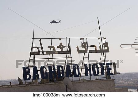 An AH-64 Apache in flight over the Baghdad Hotel in central Baghdad, Iraq. View Large Photo Image Picture - An AH-64 Apache in flight over the Baghdad Hotel in central Baghdad, Iraq.. Fotosearch