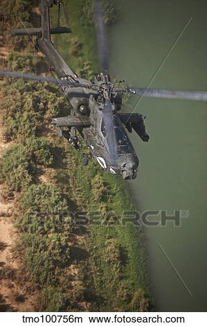 An AH-64D Apache helicopter in flight over Northern Iraq. View Large Photo Image Picture - An AH-64D Apache helicopter in flight over Northern Iraq.. Fotosearch