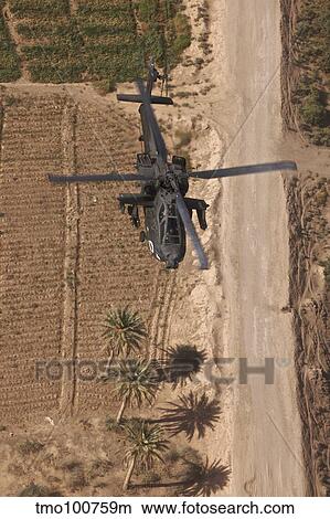 Picture - An AH-64D Apache helicopter in flight over Northern Iraq.. Fotosearch