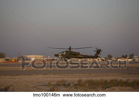 An AH-64D Apache Longbow Block III attack helicopter hovers above the runway. View Large Photo Image Picture - An AH-64D Apache Longbow Block III attack helicopter hovers above the runway.. Fotosearch