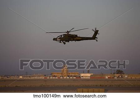 An AH-64D Apache Longbow Block III flies by the control tower on Camp Speicher. View Large Photo Image Picture - An AH-64D Apache Longbow Block III flies by the control tower on Camp Speicher.. Fotosearch